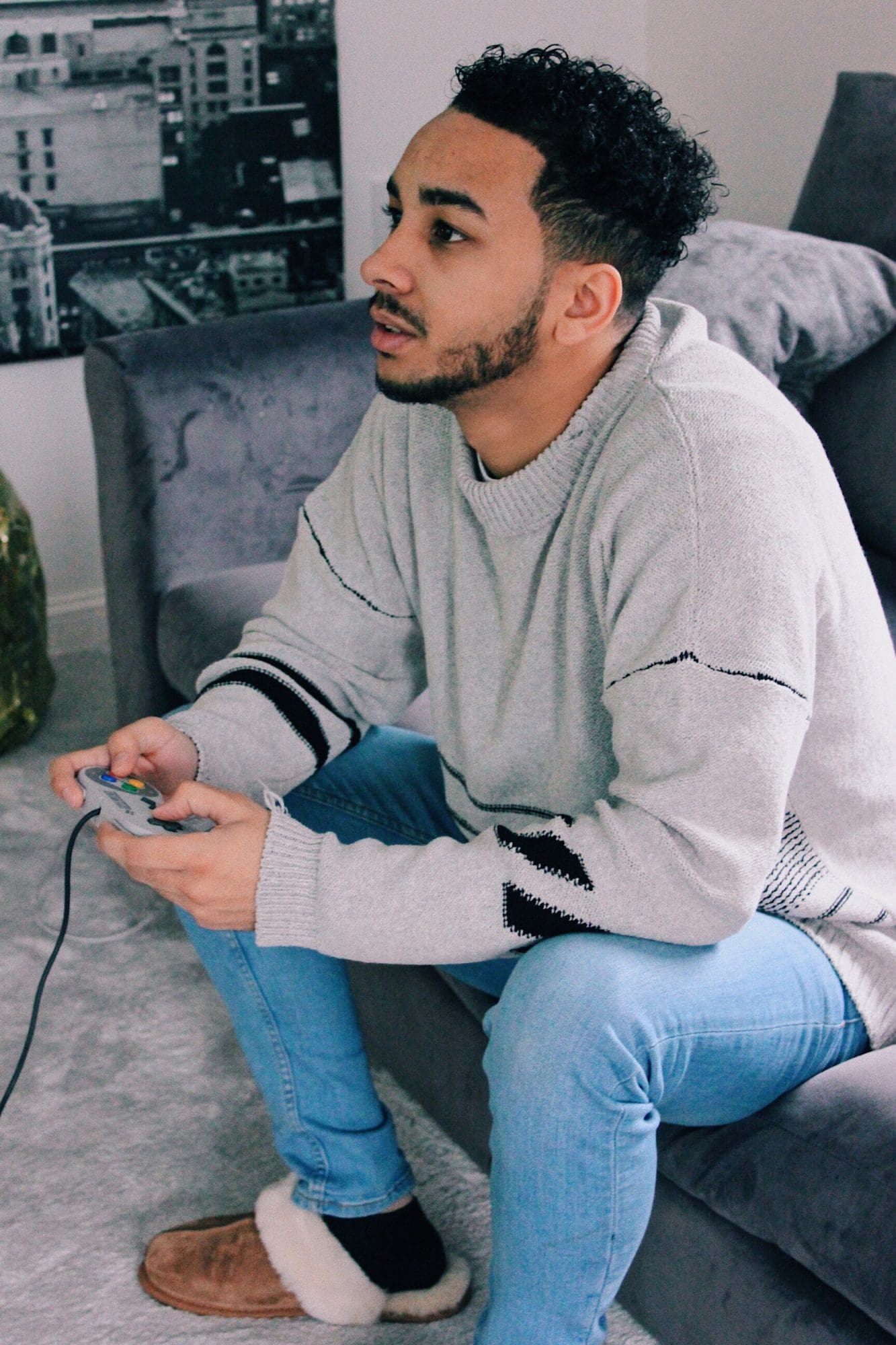 Man playing video game with branded clothing